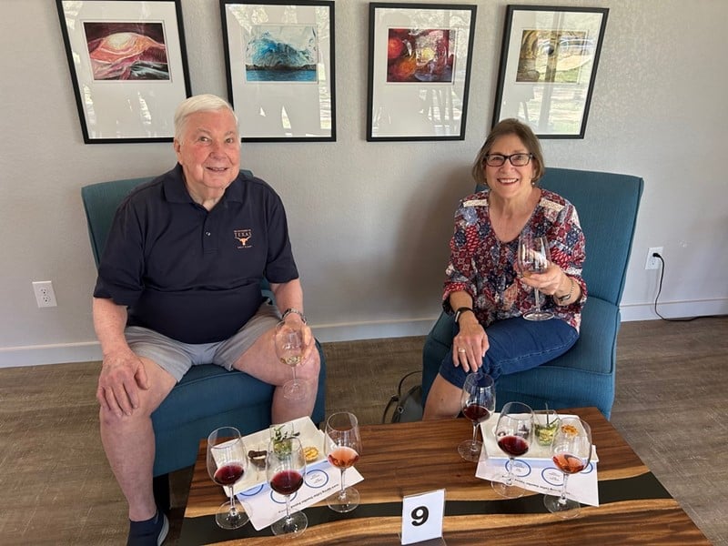 two guests at the Westcave Cellars Winery & Brewery enjoying a wine tasting